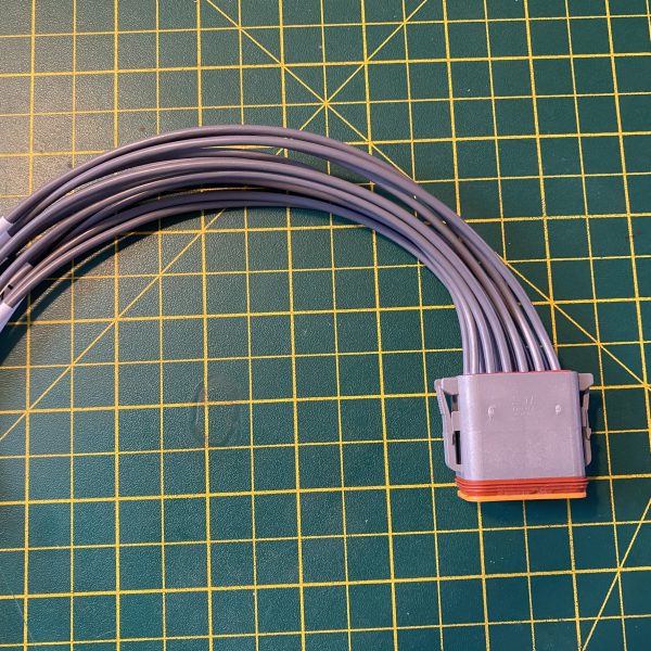 Deutsch DT06-12S-C015 12-way socket plug pigtail full assembly showing grey housing, orange E-seal and twelve cable tails — Voltforge 430019-000